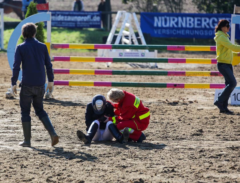 Sports Medicine Physician checks elbow injury of the player during an event.