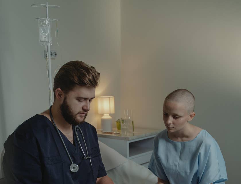 Staff nurse explains to patient treatment plans and medications as directed by the doctor