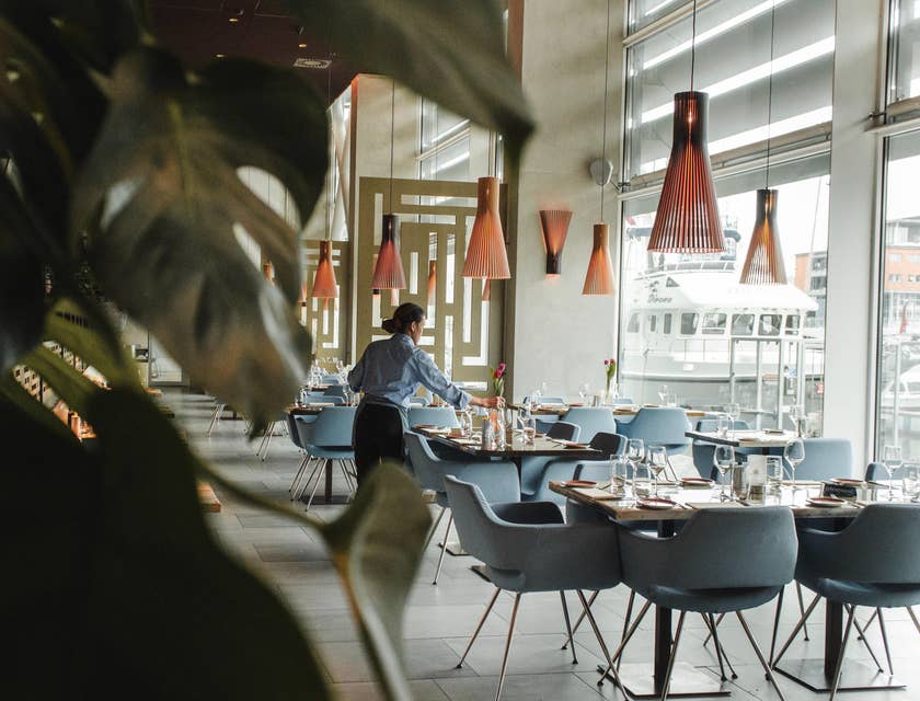 A steward making sure restaurant is clean and tidy.
