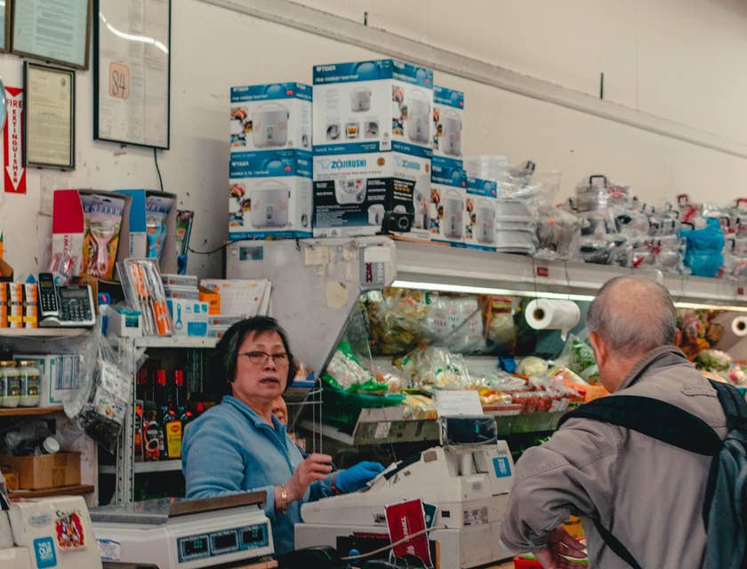 Store supervisor taking over the counter to deal with customer's complaint.