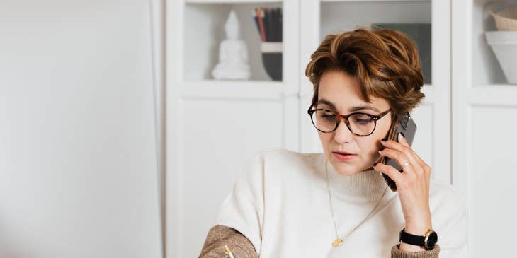 Strategic sourcing manager calls her team to provide cost estimates of a new business venture while listing on a paper.
