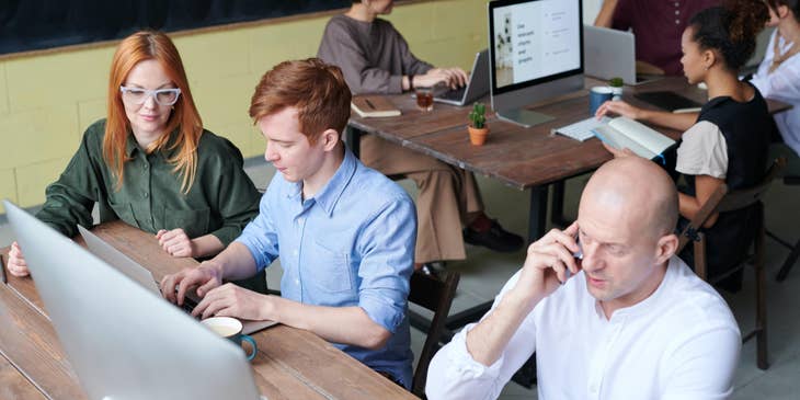 Strategist works with together with his team on a new project while others are doing research