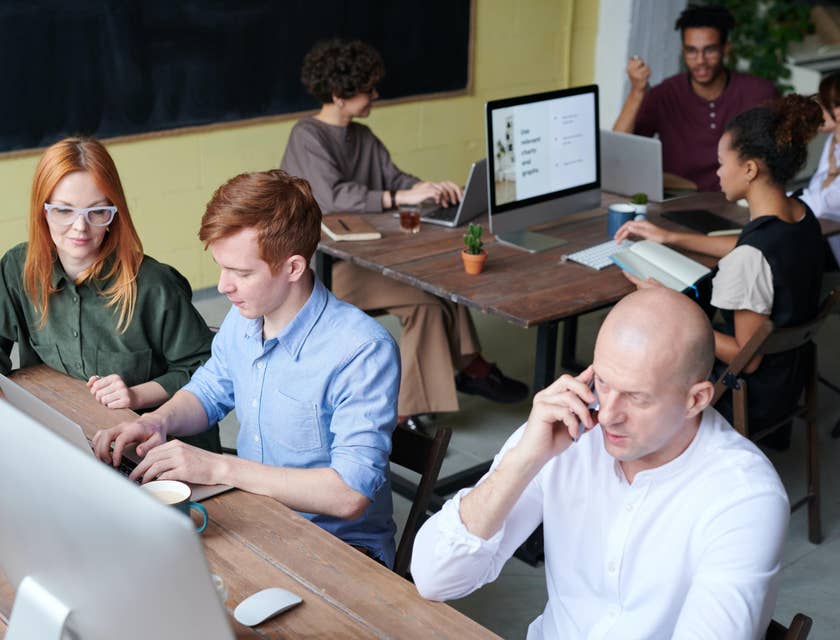 Strategist works with together with his team on a new project while others are doing research
