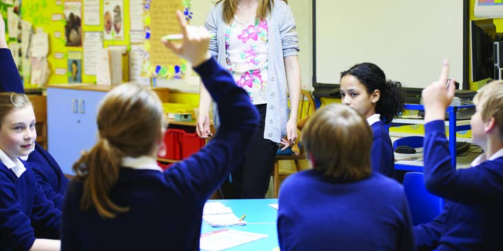 Substitute Teacher listens to her students' questions during class