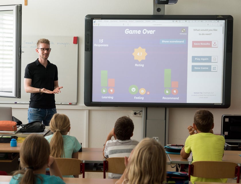 Teacher gives an interactive lesson to his students on a projector.