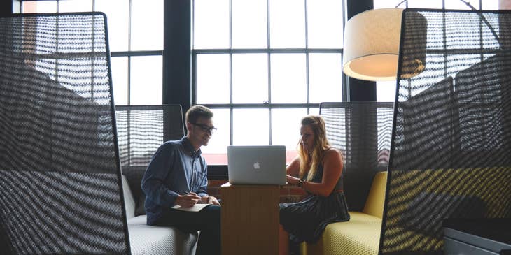 Travel consultant provides several travel arrangements to the client on her laptop