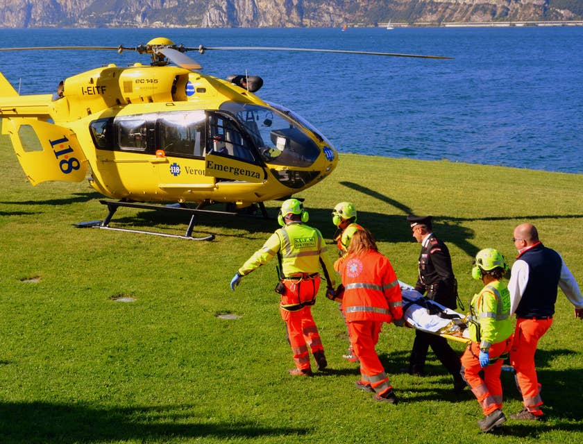 Travel Nurse helps an injured patient in a stretcher to the chopper to the hospital for treatment