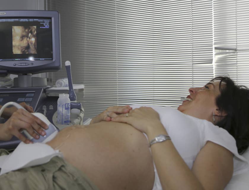 Ultrasound technician shows still image of her baby through while explaining the procedure