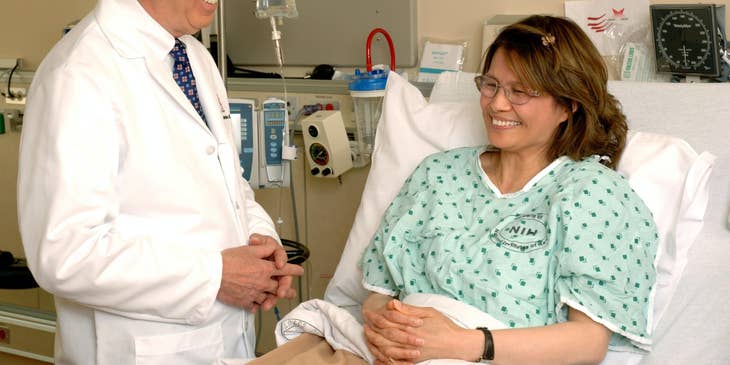 Urologist is very happy sharing the good news with the patient in the hospital