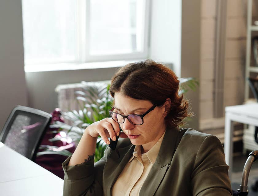 VP of operations hosts meeting over the phone while looking at laptop