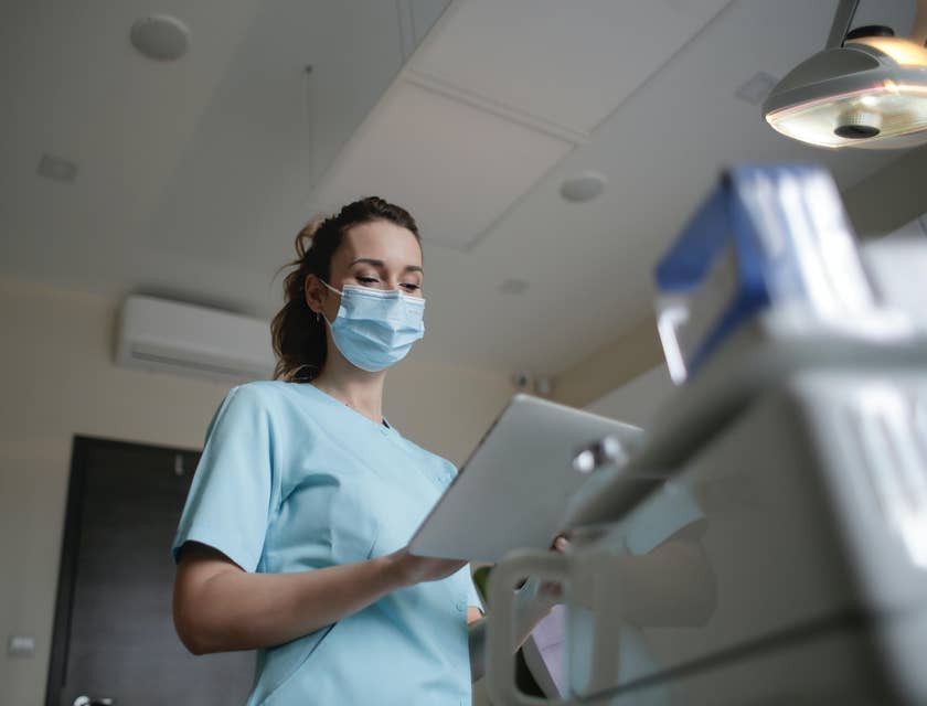 Vascular technologist reviewing patient's information before doing ultrasound procedure