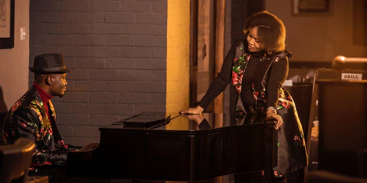 Vocal Coach plays the piano as the singer prepares to sing for a concert