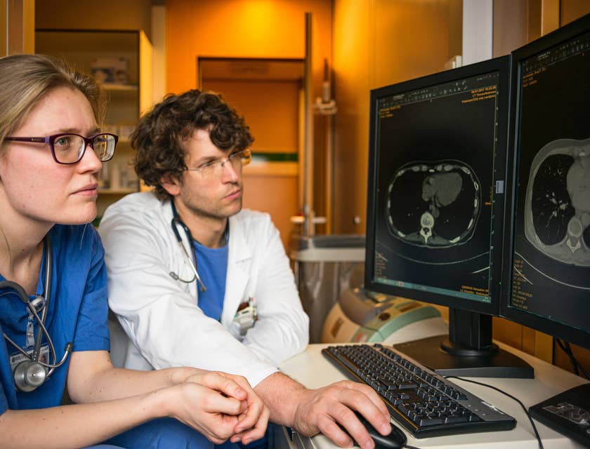 Healthcare workers studying an image on a screen.