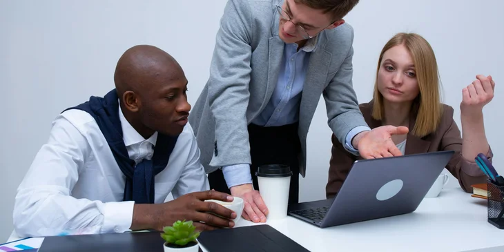 An account manager explaining to the clients some of the benefits of the company's products if he chooses to purchase.