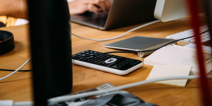 Account Manager using a MacBook besides a calculator.