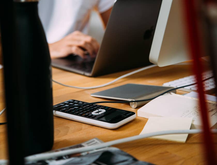 Account Manager using a MacBook besides a calculator.