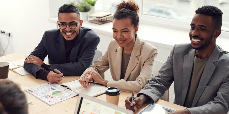 An accounting specialist discussing a project with three co-workers.