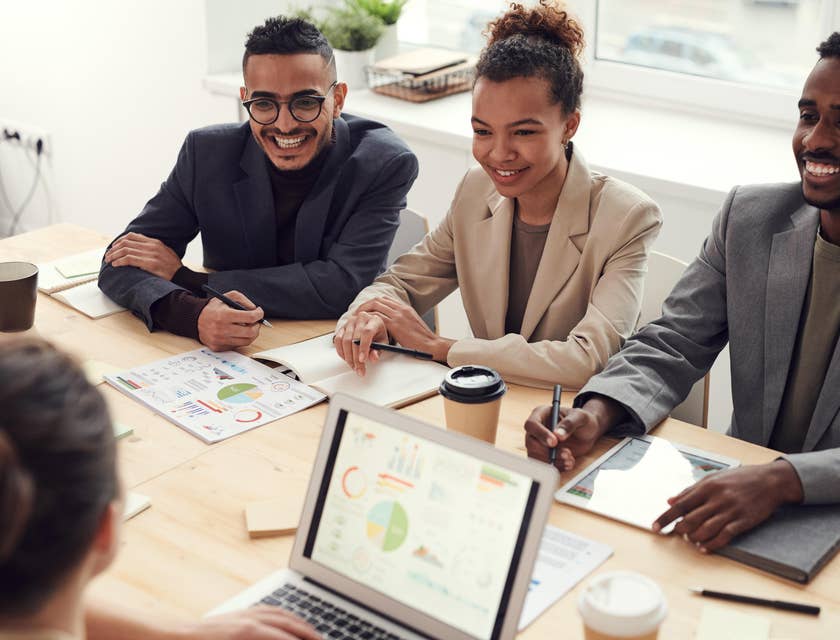 An accounting specialist discussing a project with three co-workers.