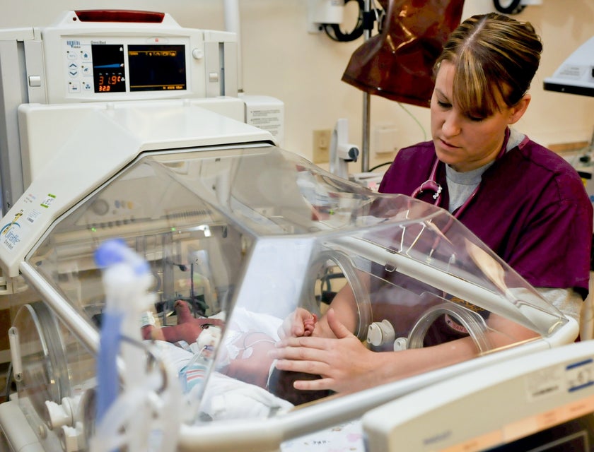 Acute Care Nurse performs examination to a newborn.