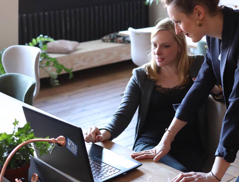 A woman and her admin assistant looking at a laptop screen