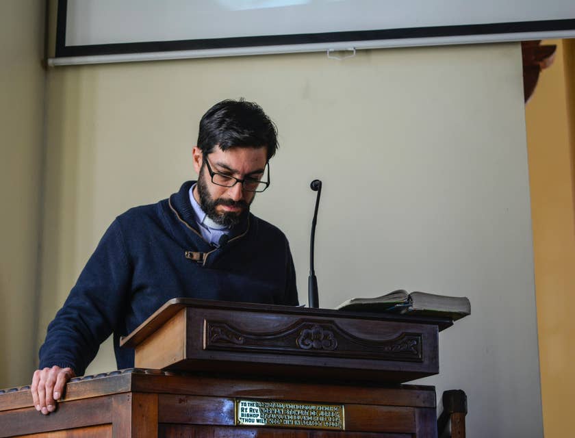 Admissions Director speaks to students about the admission process on a podium