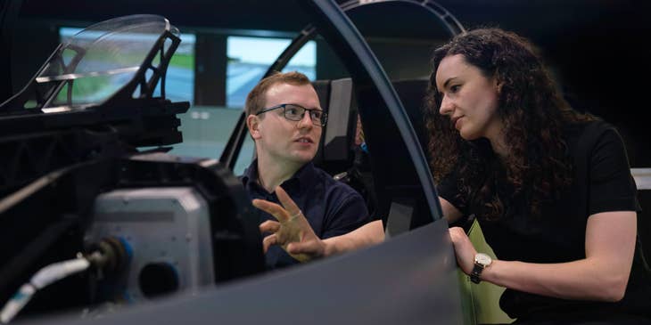female Aerospace Engineer setting her colleague's expectations regarding the flight simulator pod