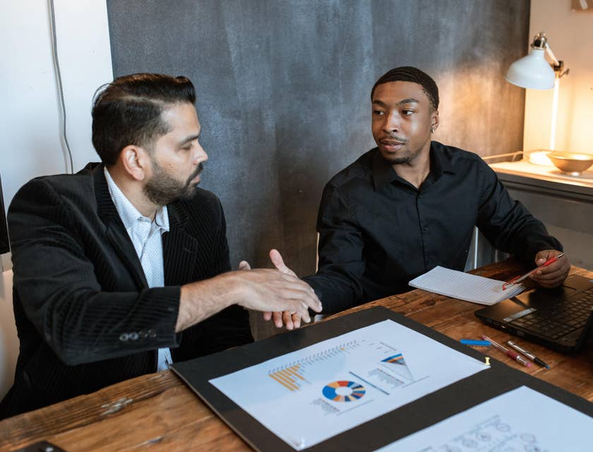 An Agency Manager doing a handshake with an employee.