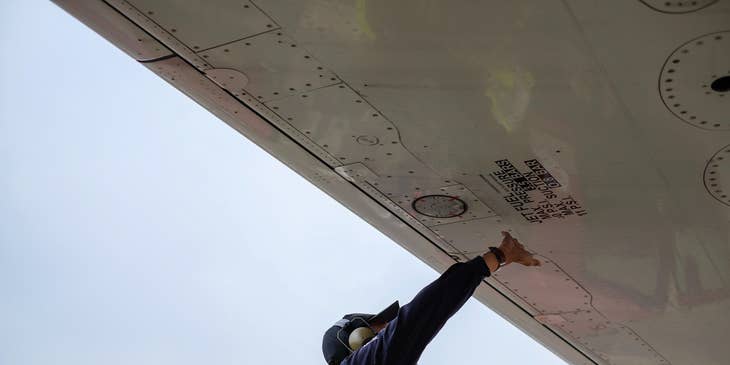Aircraft Maintenance Engineer checking the plane's fuel pit
