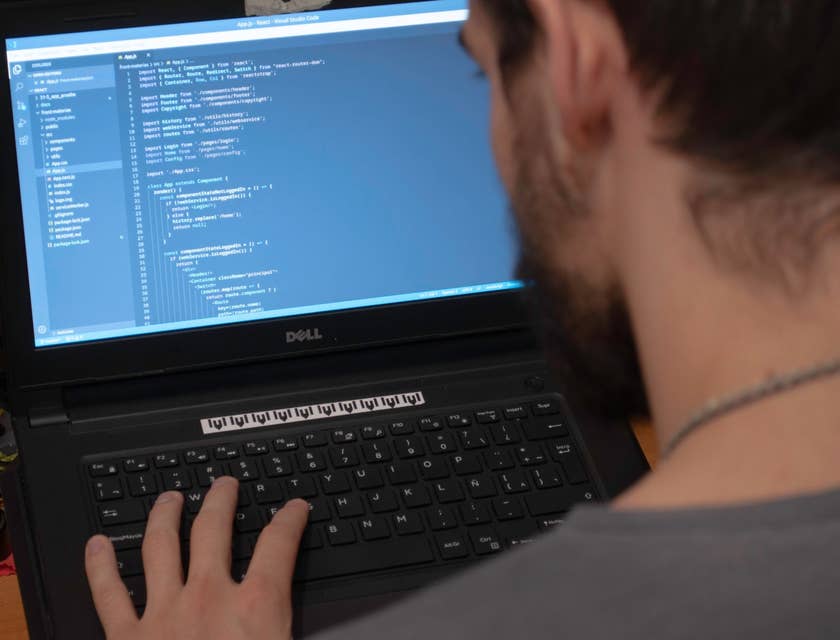 Android Developer working on program updates using his laptop