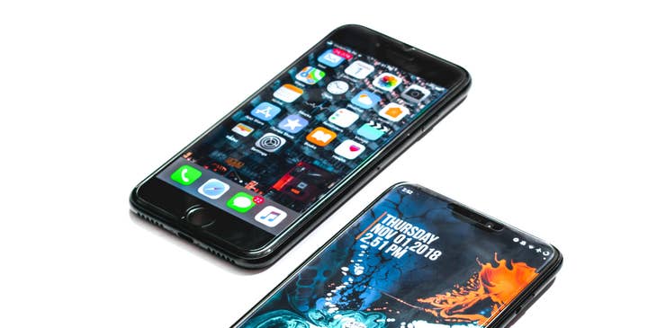 Two android phones placed next to each other against a white background