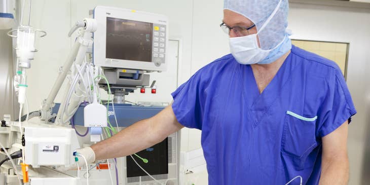Anesthetist administering anesthesia to a patient.