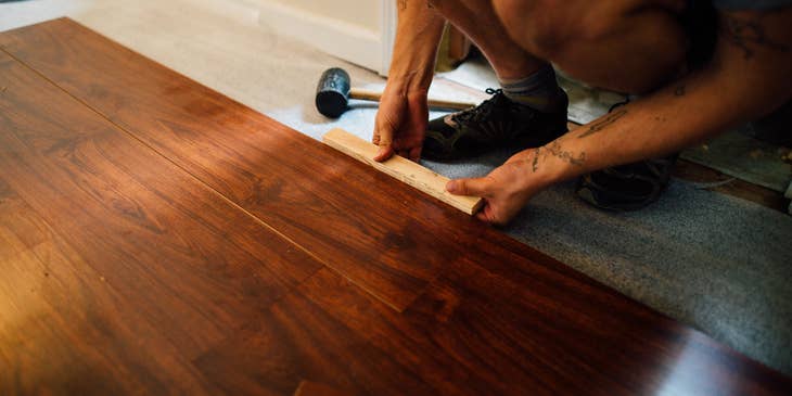 Apartment Maintenance Technician replacing wood floor