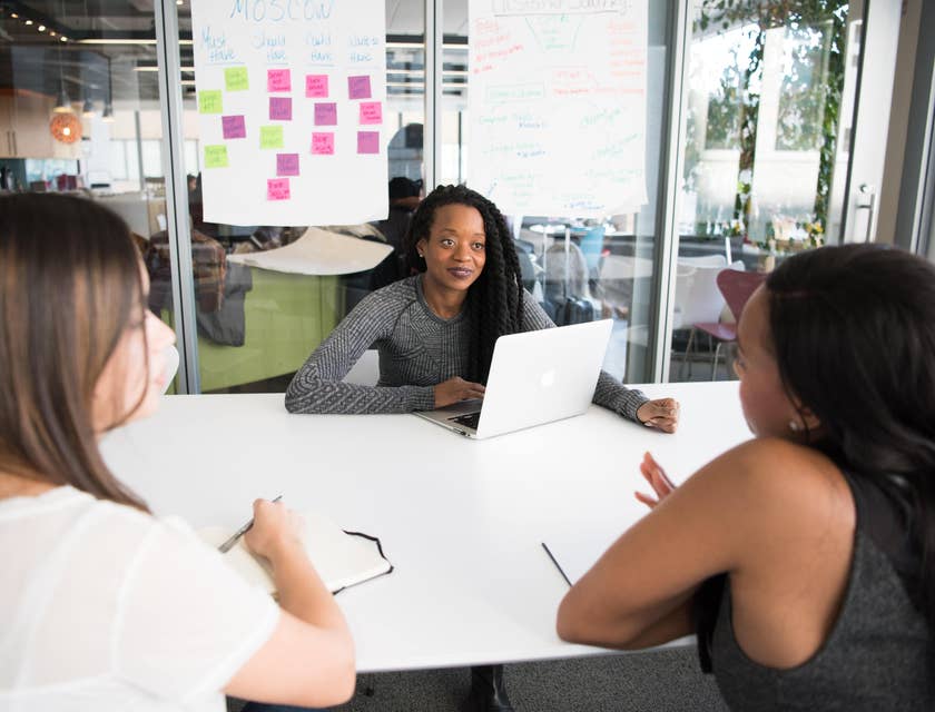 female Application Manager collating feedback from her team members about the valuable programs they use for work