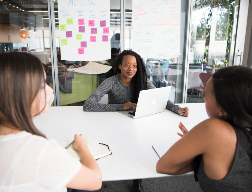 female Application Manager collating feedback from her team members about the valuable programs they use for work