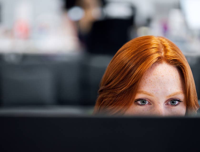 Application Support Engineer looking at her monitor to track the progress of software installation