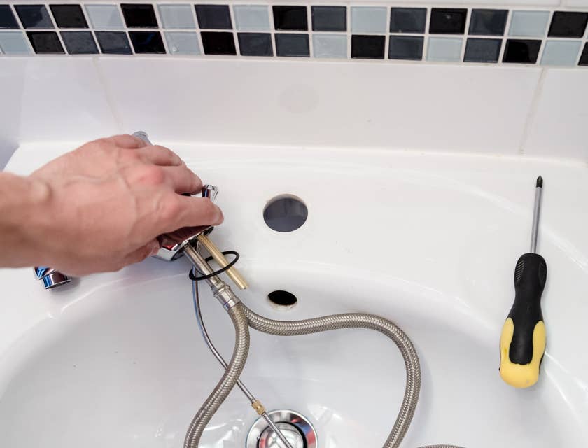 Apprentice Plumber repairing a faucet.