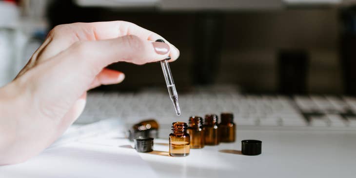 Aromatherapist preparing blends of oils.
