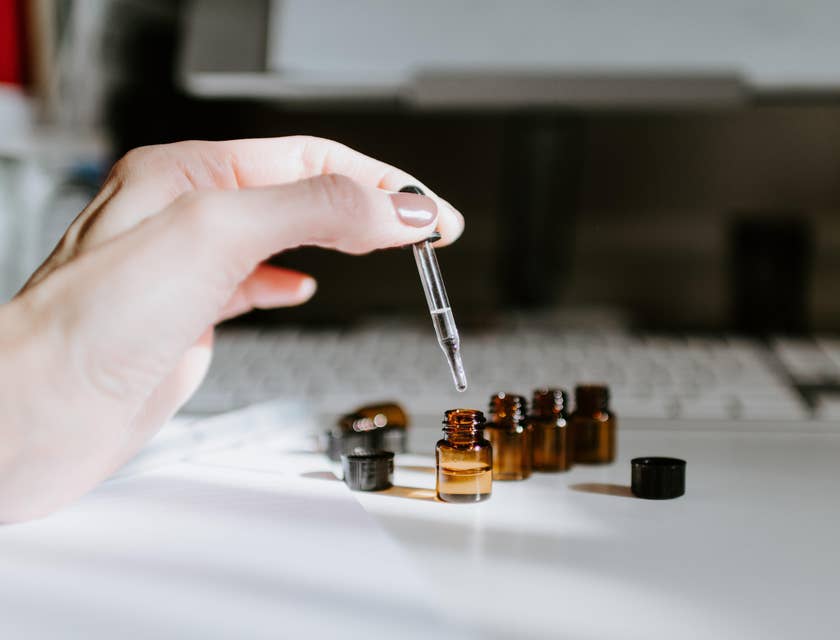 Aromatherapist preparing blends of oils.