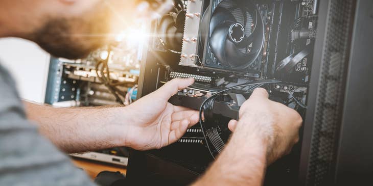 An Assembler pulling out a defective part of a Computer CPU to be repaired or replaced.