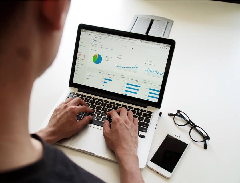 Asset Manager checking on some graphs on a Macbook