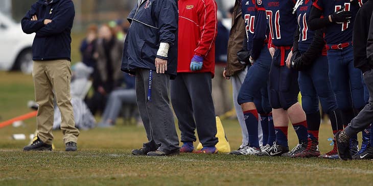 Football coach and assistant coach watching a game