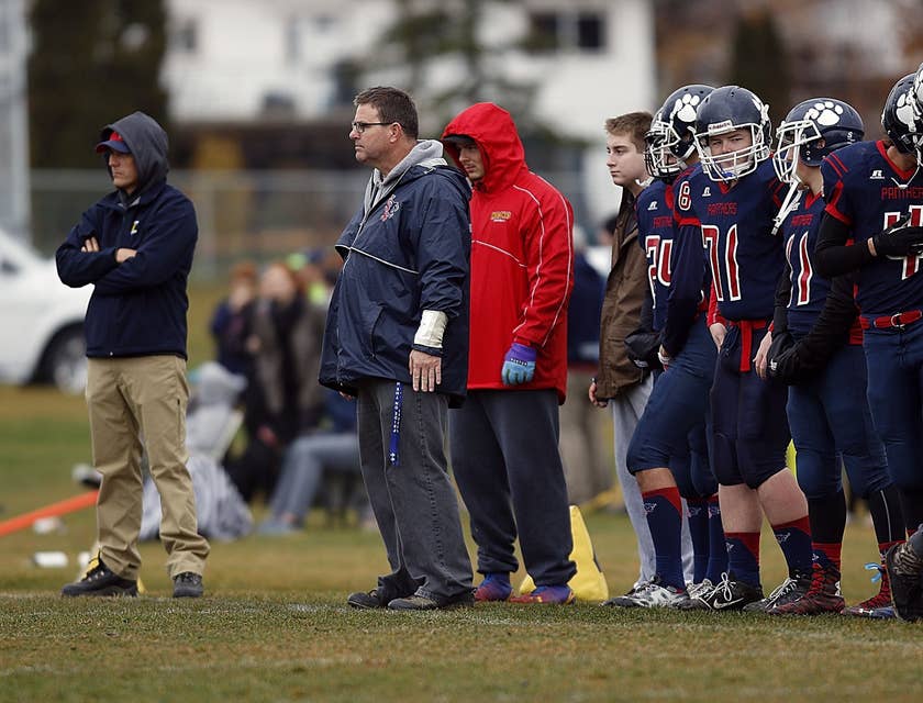 Football coach and assistant coach watching a game