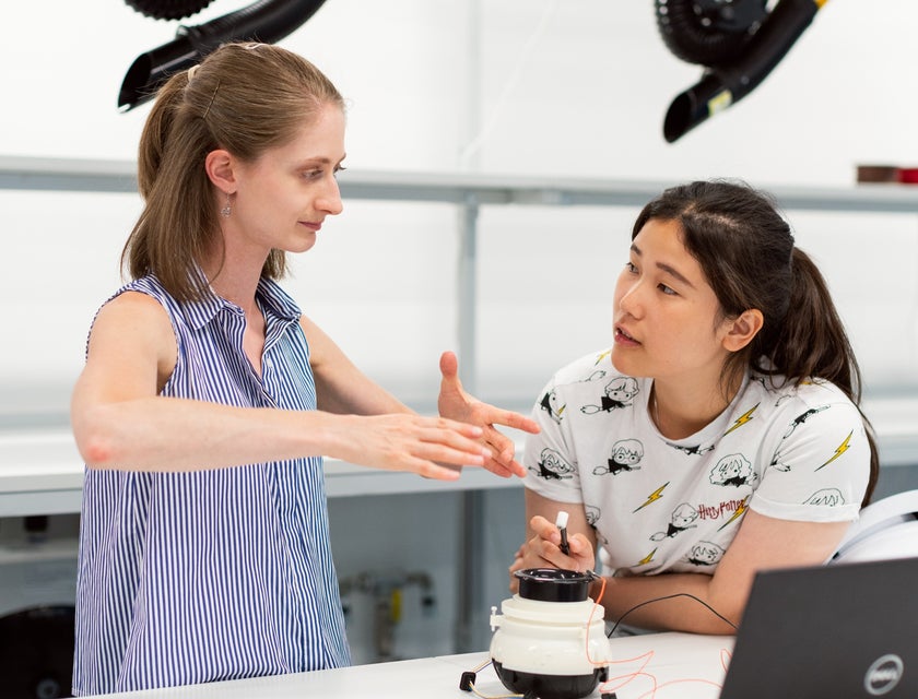 Assistant Engineer explains model design to her supervisor while testing the product