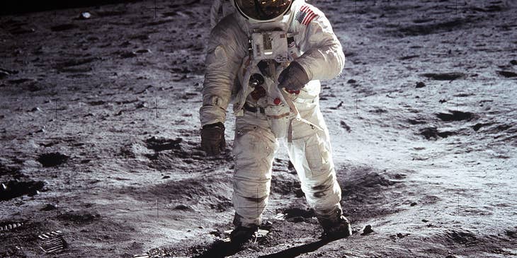 Astronomers on the moon gathering sample rocks to be sent back to earth.