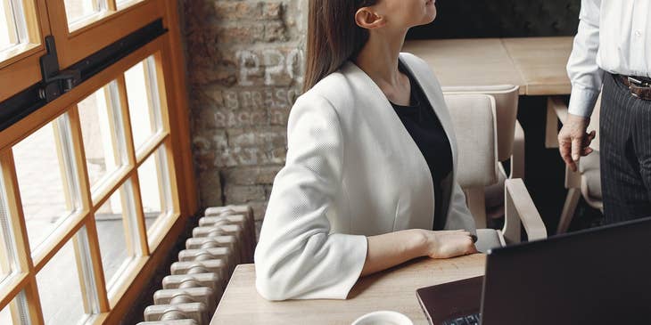 Man talking to a woman in an office.