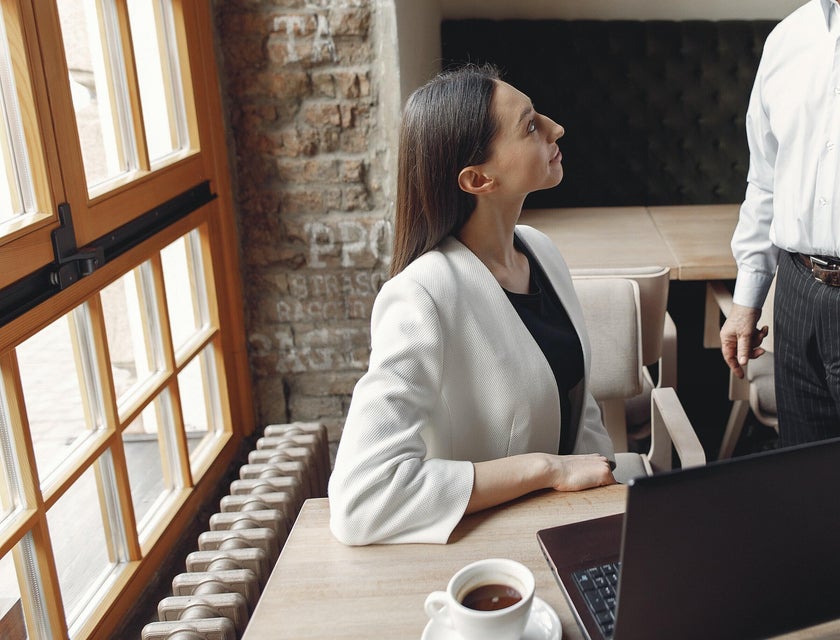 Man talking to a woman in an office.