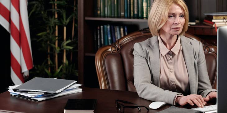 A Female Attorney sitting in her office working on some legal documents.