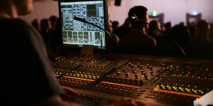 Technician providing audio-video support in a live show