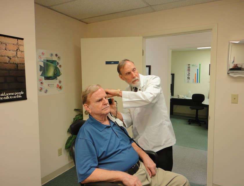 Audiologist conducting auditory test on patient.