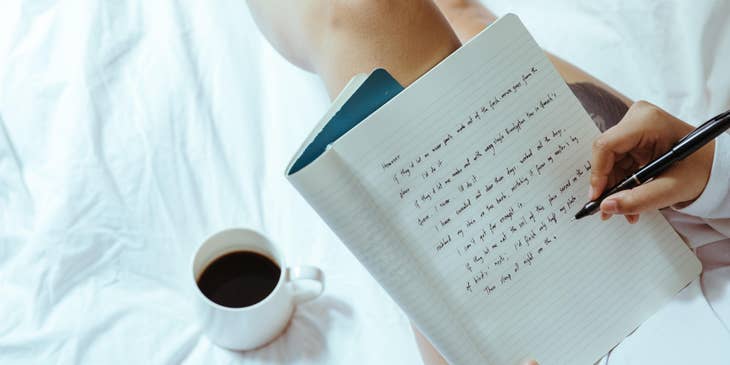 Author writing her newest piece while enjoying a cup of coffee